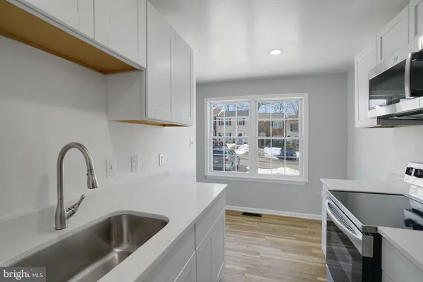 a view of staircase with wooden floor and white walls