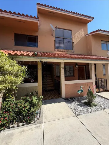 a front view of a house with plants