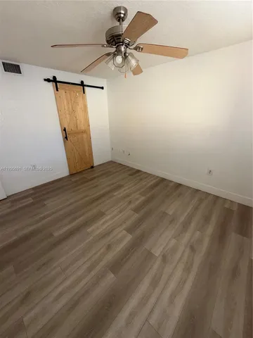 a view of a room with wooden floor