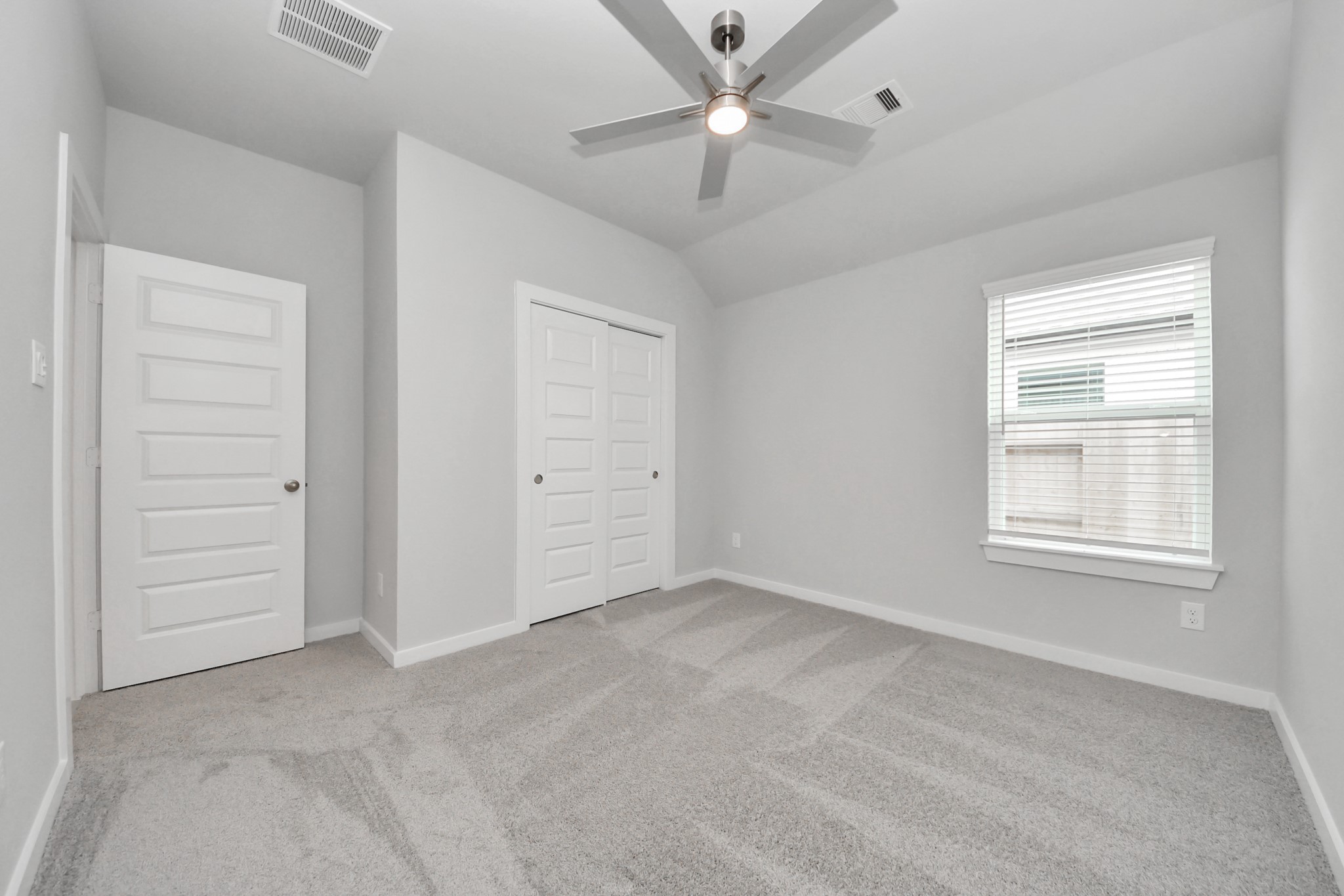 24518 Broad Park Spring, TX 77373 - Photo 7 of 29 Generously sized secondary bedrooms featuring spacious closets, soft and inviting carpeting underfoot, large windows allowing plenty of natural light, and the added touch of privacy blinds for your personal retreat. Sample photo of completed home with similar floor plan. Actual colors and selections may vary.
