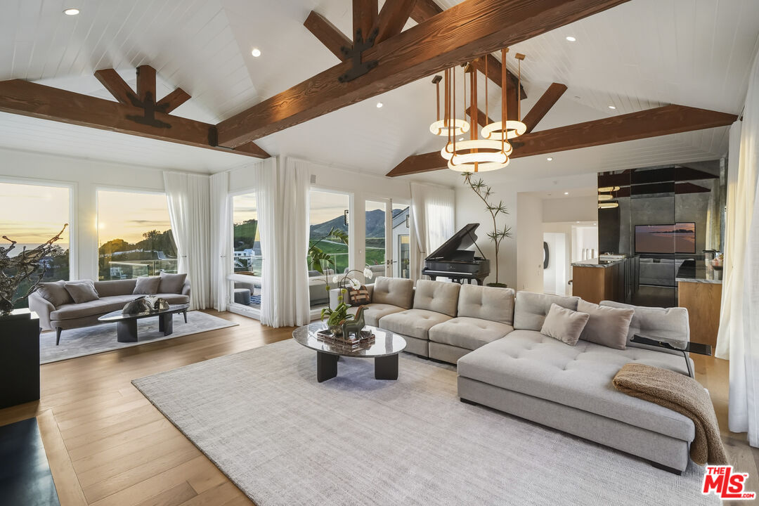 3140 Sweetwater Mesa Road Malibu, CA 90265 - Photo 12 of 71 a living room with furniture and a large window