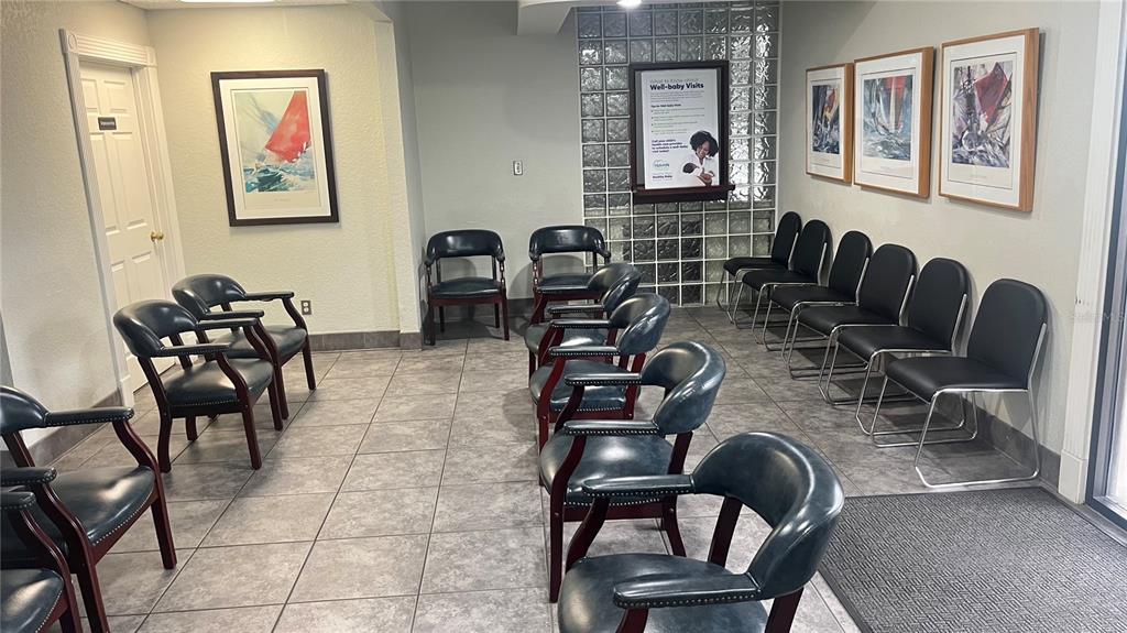 801 Marshall Farms Road Ocoee, FL 34761 - Photo 10 of 16 a work room with furniture a rug and wall paintings