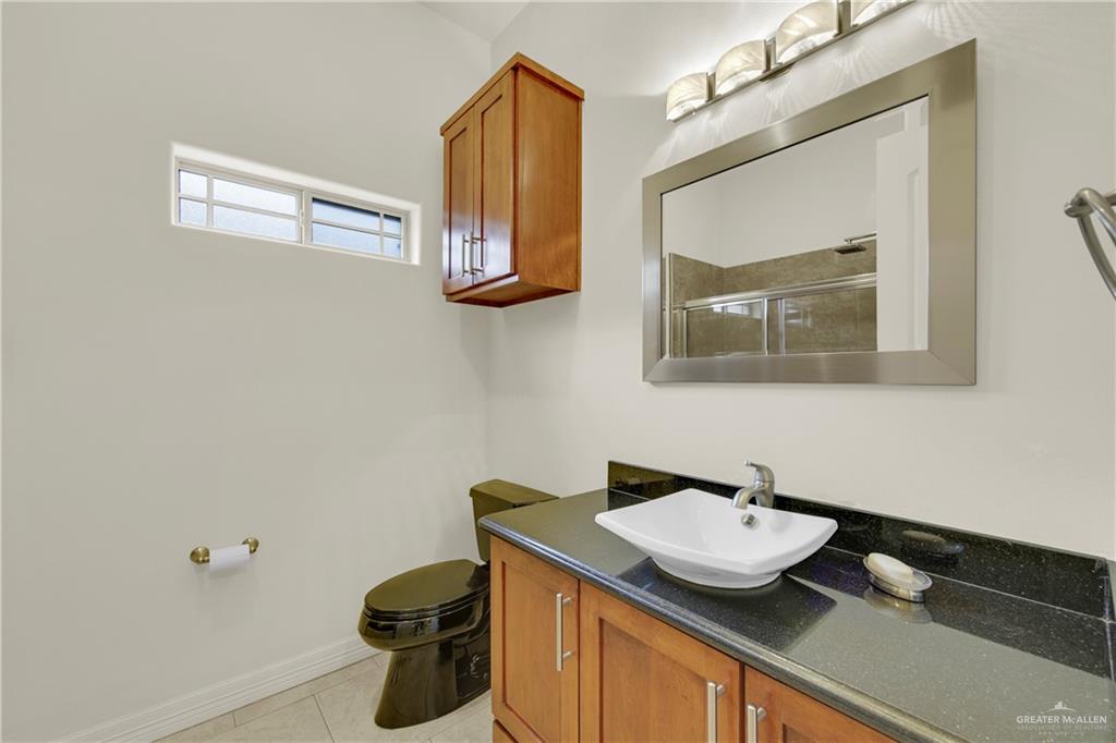 3601 North Toledo Street Pharr, TX 78577 - Photo 13 of 21 a bathroom with a sink and a mirror
