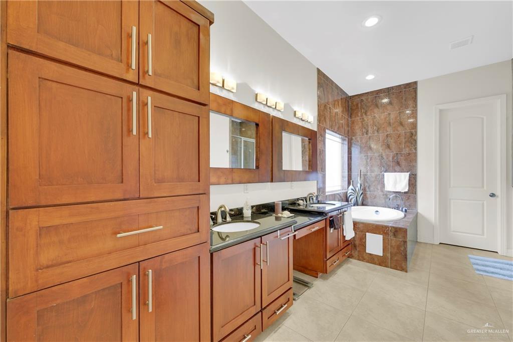 3601 North Toledo Street Pharr, TX 78577 - Photo 16 of 21 a kitchen with stainless steel appliances granite countertop a sink and a refrigerator