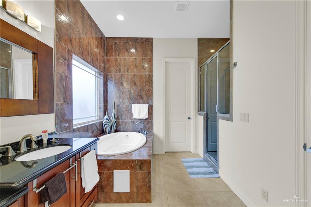 3601 North Toledo Street Pharr, TX 78577 - Photo 17 of 21 a bathroom with a sink a toilet a mirror and a shower