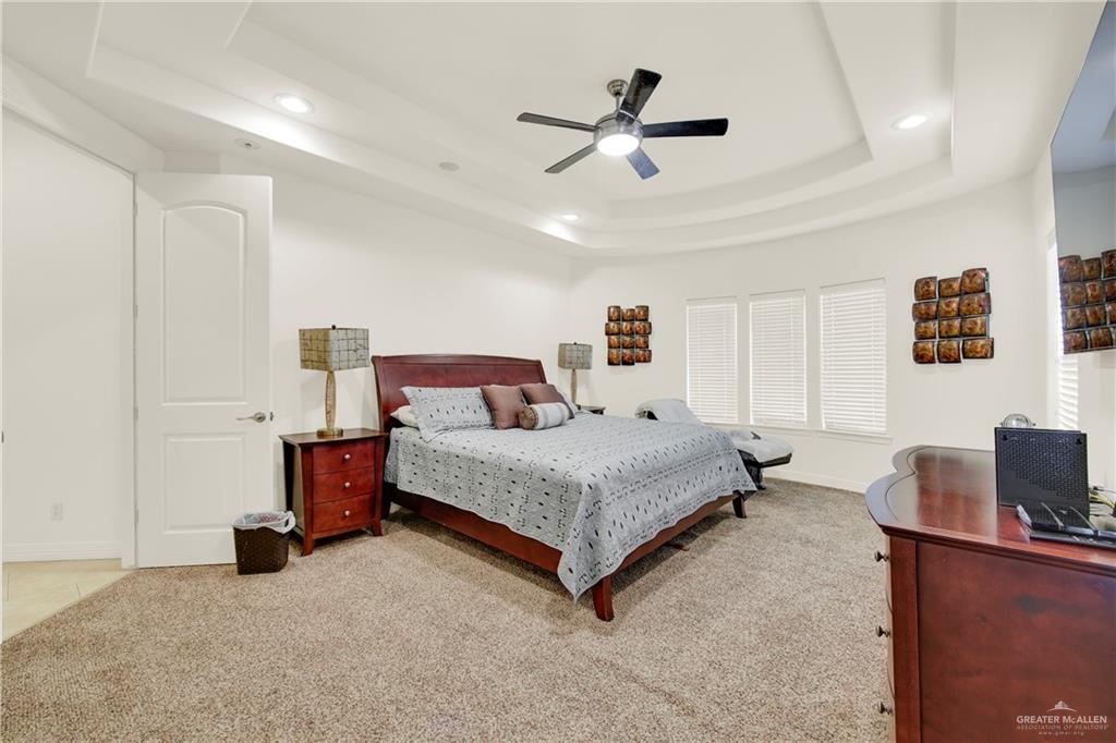 3601 North Toledo Street Pharr, TX 78577 - Photo 18 of 21 a spacious bedroom with a bed and a ceiling fan