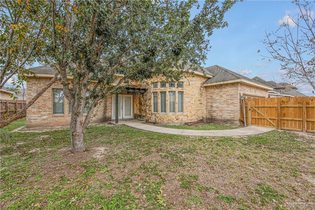 3601 North Toledo Street Pharr, TX 78577 - Photo 19 of 21 a view of a house with a tree and a yard