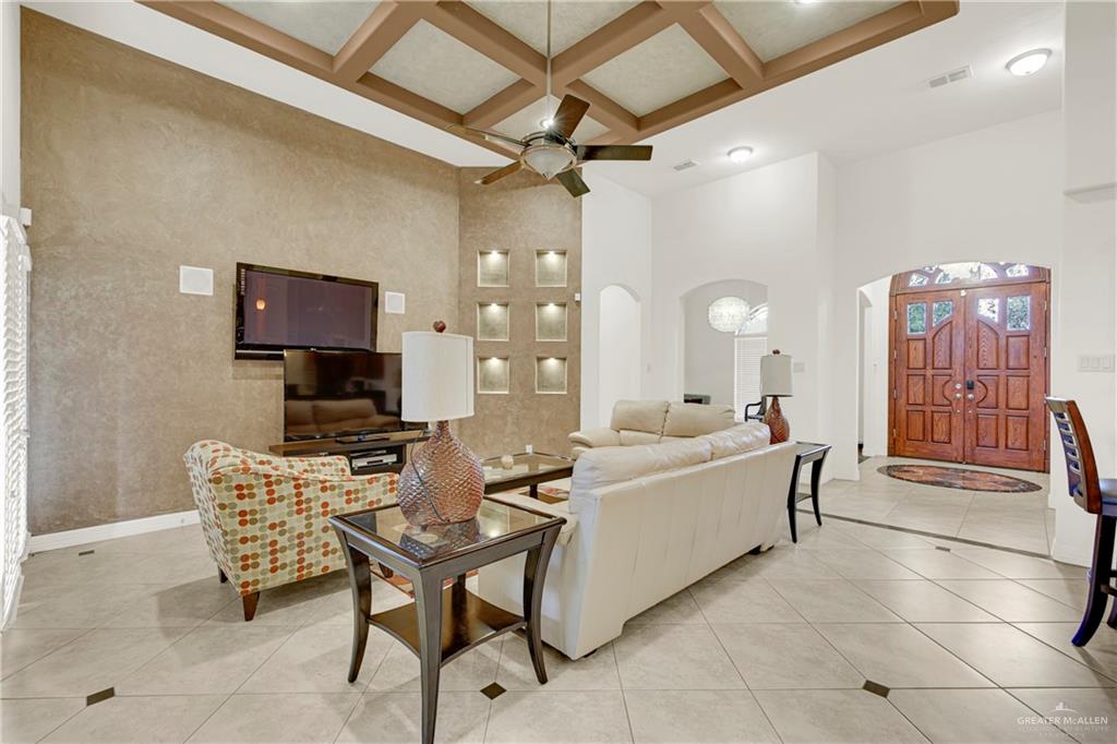 3601 North Toledo Street Pharr, TX 78577 - Photo 7 of 21 a living room with furniture a flat screen tv and kitchen view