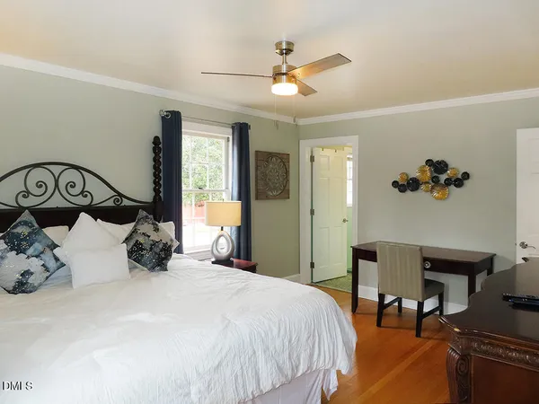 a bedroom with a large bed and a chandelier