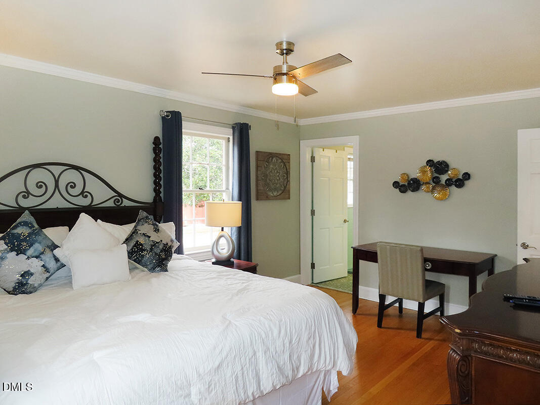 8743 Highway 751 Durham, NC 27713 - Photo 14 of 21 a bedroom with a large bed and a chandelier