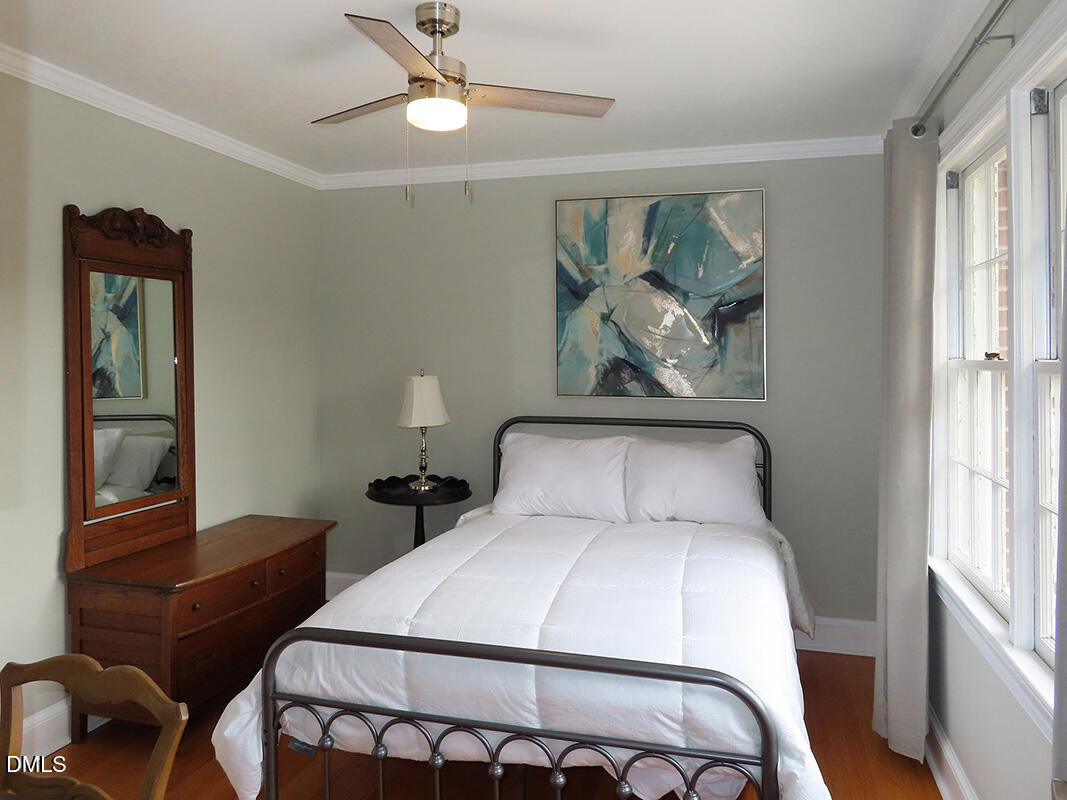 8743 Highway 751 Durham, NC 27713 - Photo 15 of 21 a bedroom with a bed and a chandelier