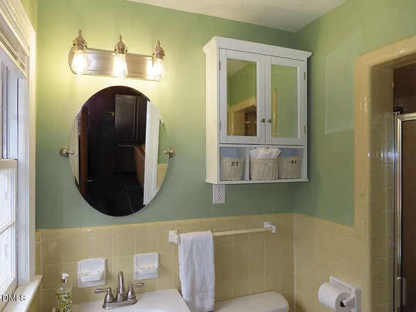 a bathroom with a toilet and a mirror