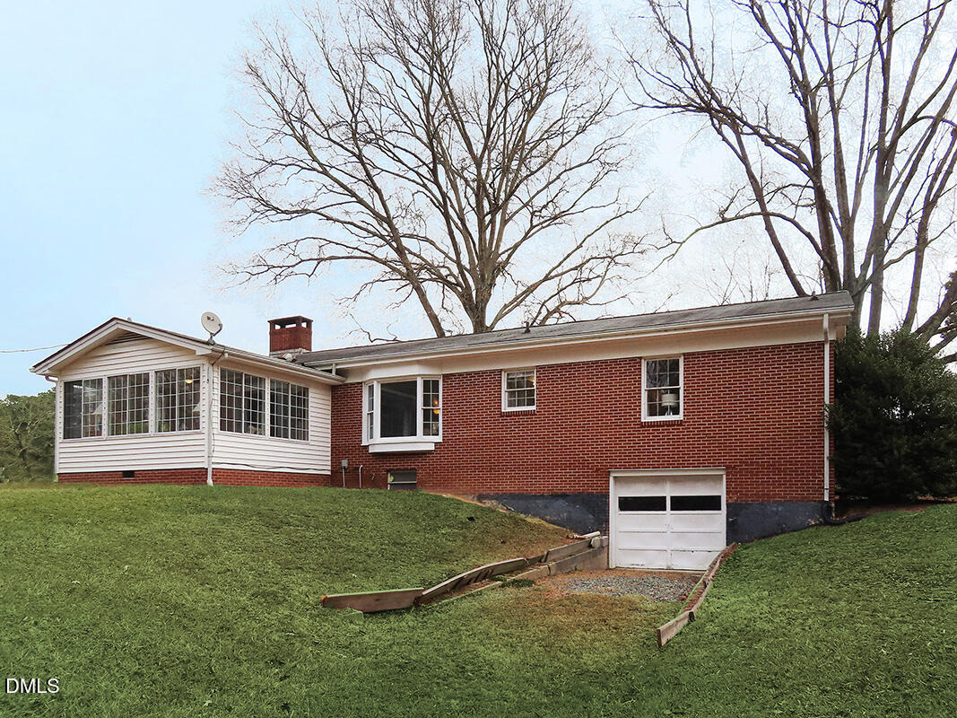 8743 Highway 751 Durham, NC 27713 - Photo 20 of 21 a front view of a house with a garden