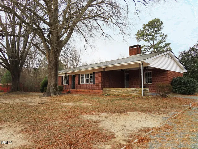 a house that has a tree in front of it