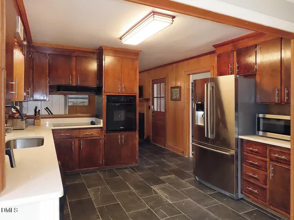 a kitchen with stainless steel appliances granite countertop a refrigerator stove and sink