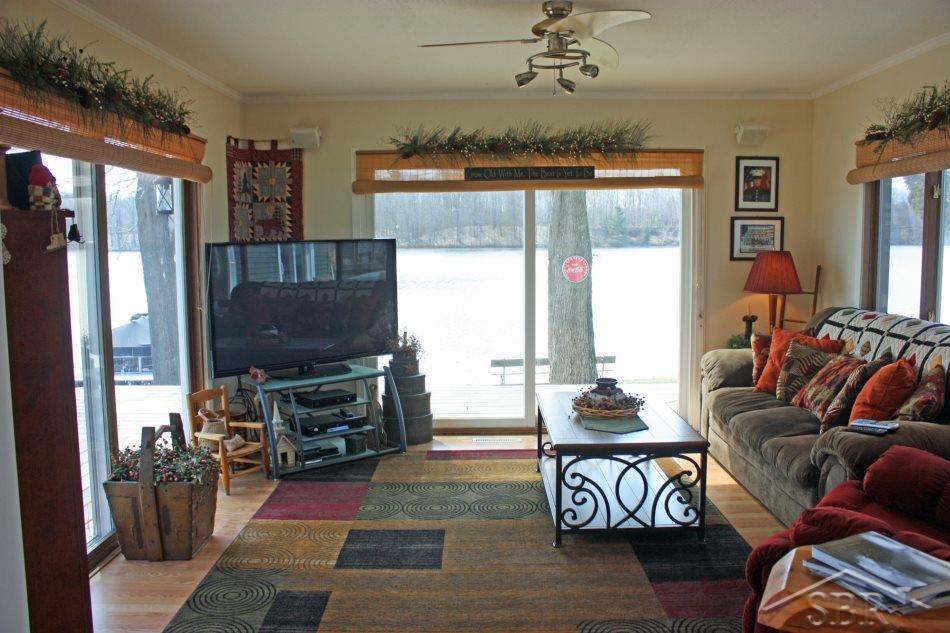 3072 South Whitney Beach Road Beaverton, MI 48612 - Photo 9 of 21 Family room is open from the dining and kitchen area. Did you notice there are 2 sliding doors and a huge window which maximize the sun and offer amazing waterfront views.