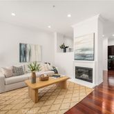 a living room with furniture fireplace and wooden floor