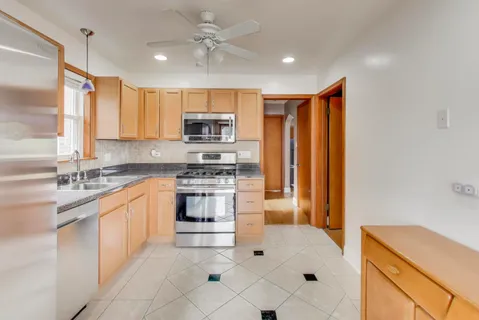 a kitchen with stainless steel appliances a stove sink and microwave