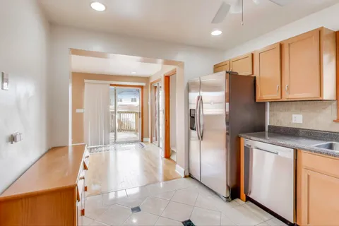 a kitchen with stainless steel appliances granite countertop a refrigerator and a sink