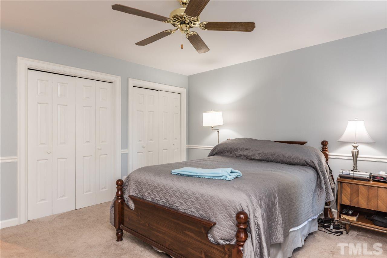 3104 Hickory Road Raleigh, NC 27616 - Photo 14 of 25 a bedroom with a bed and a chandelier