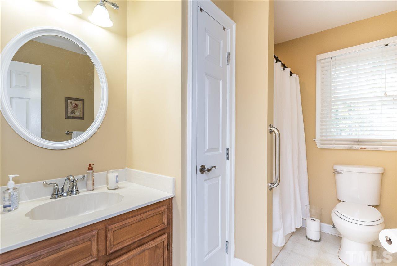 3104 Hickory Road Raleigh, NC 27616 - Photo 20 of 25 a bathroom with a granite countertop sink vanity mirror and a toilet