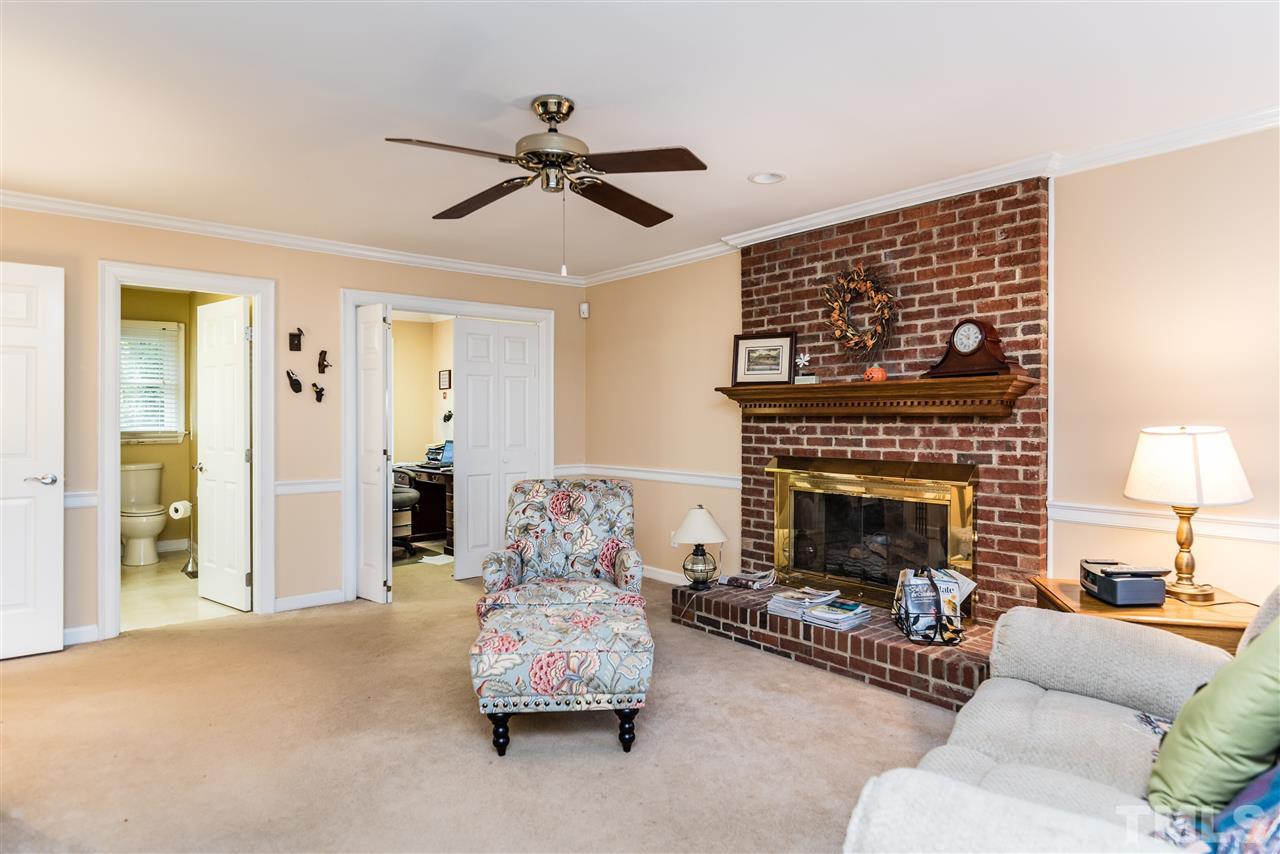 3104 Hickory Road Raleigh, NC 27616 - Photo 4 of 25 a living room with furniture and a fireplace