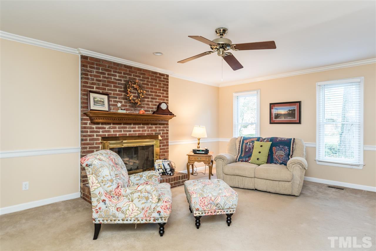 3104 Hickory Road Raleigh, NC 27616 - Photo 5 of 25 a living room with furniture and a fireplace