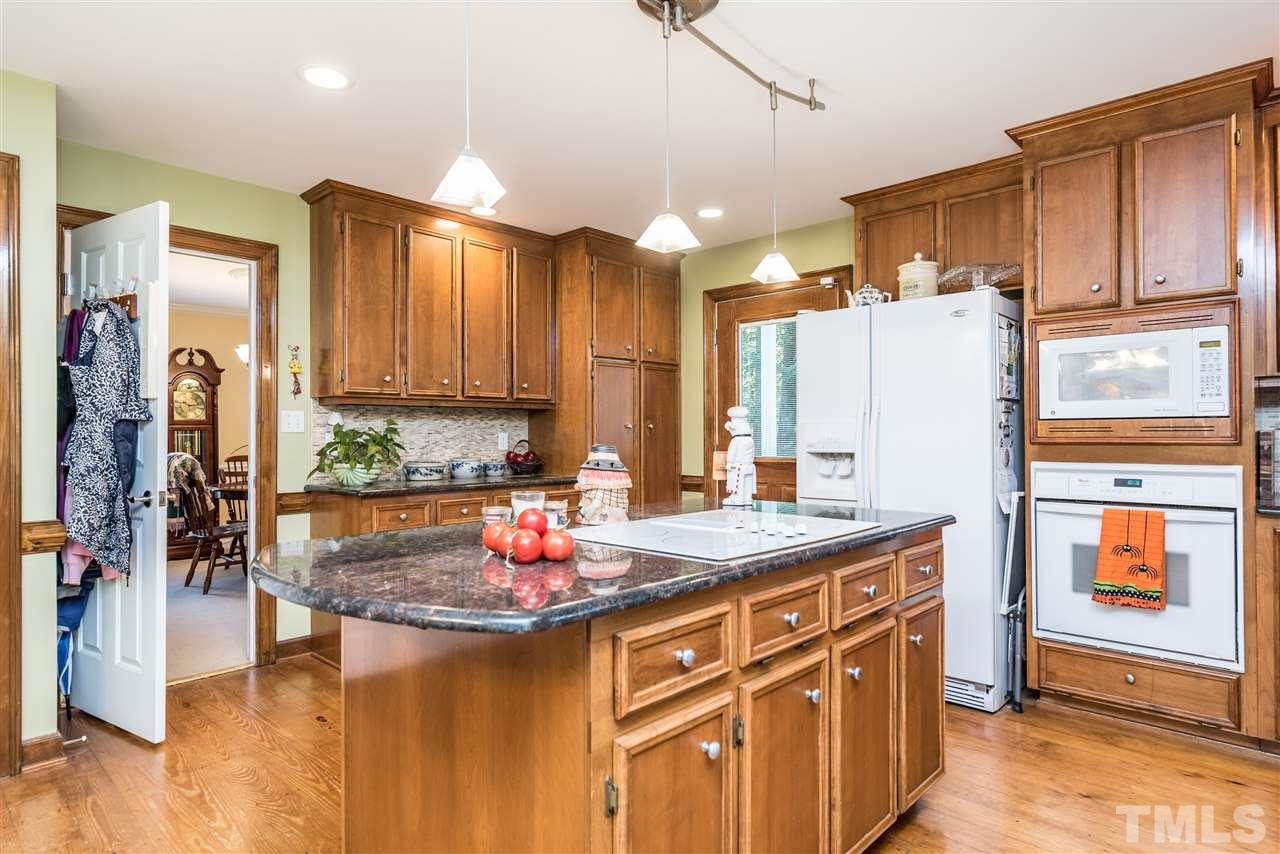 3104 Hickory Road Raleigh, NC 27616 - Photo 8 of 25 a kitchen with stainless steel appliances granite countertop a sink a refrigerator and a stove