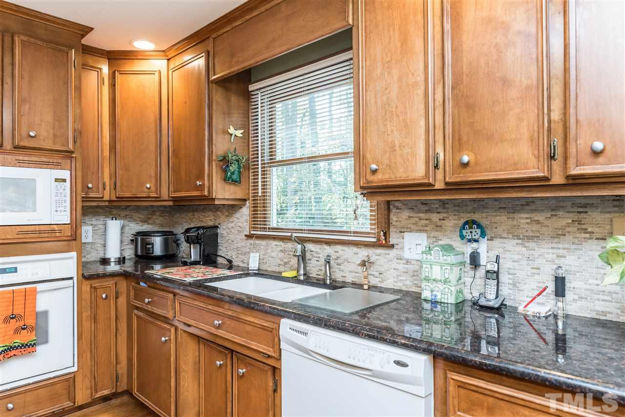 3104 Hickory Road Raleigh, NC 27616 - Photo 10 of 25 a kitchen with stainless steel appliances granite countertop a sink a stove and cabinets