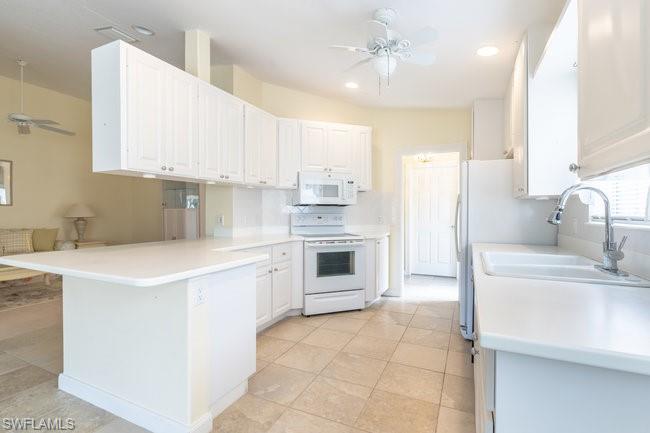 7630 Novara Court Naples, FL 34114 - Photo 11 of 33 a kitchen with stainless steel appliances granite countertop a sink stove and refrigerator