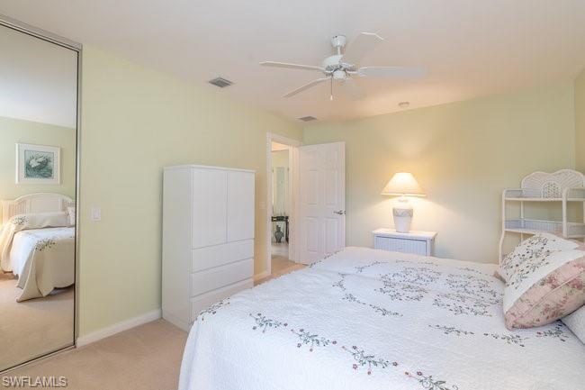 7630 Novara Court Naples, FL 34114 - Photo 22 of 33 a bedroom with a bed and a lamp