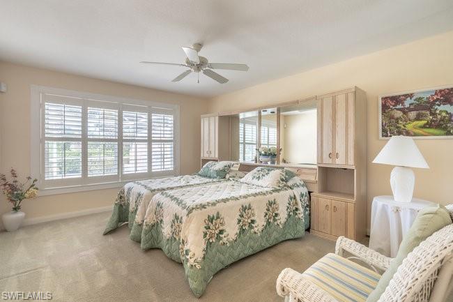 7630 Novara Court Naples, FL 34114 - Photo 24 of 33 a bedroom with a bed and a chandelier