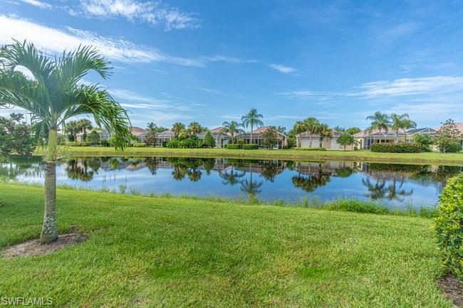 7630 Novara Court Naples, FL 34114 - Photo 31 of 33 a view of a lake with houses in the background