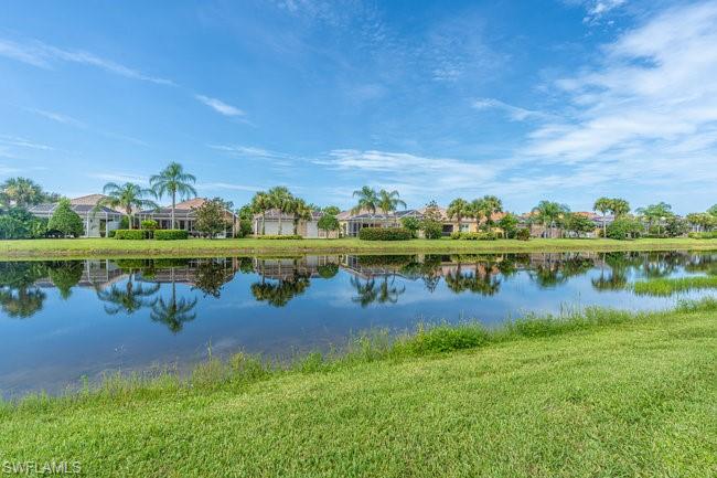 7630 Novara Court Naples, FL 34114 - Photo 32 of 33 a view of a lake with houses in the back