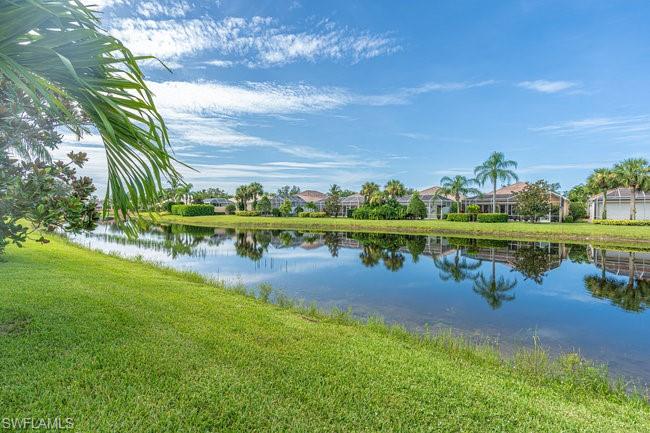7630 Novara Court Naples, FL 34114 - Photo 33 of 33 a view of a lake with houses in the back