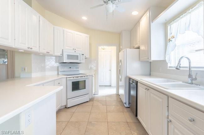 7630 Novara Court Naples, FL 34114 - Photo 10 of 33 a kitchen with a stove sink and refrigerator