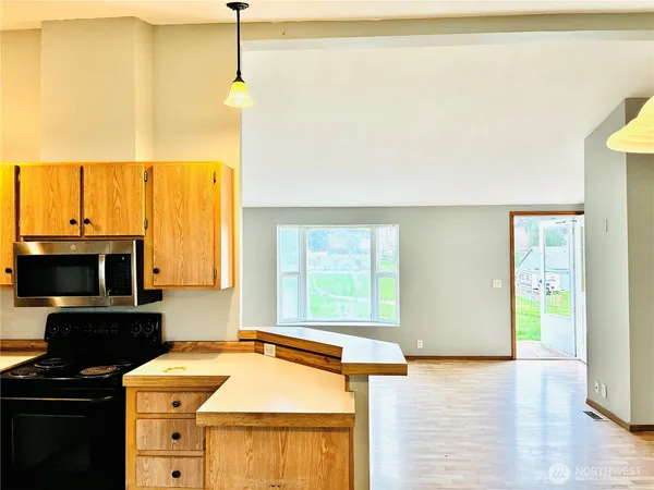 a kitchen with a stove a sink and a microwave