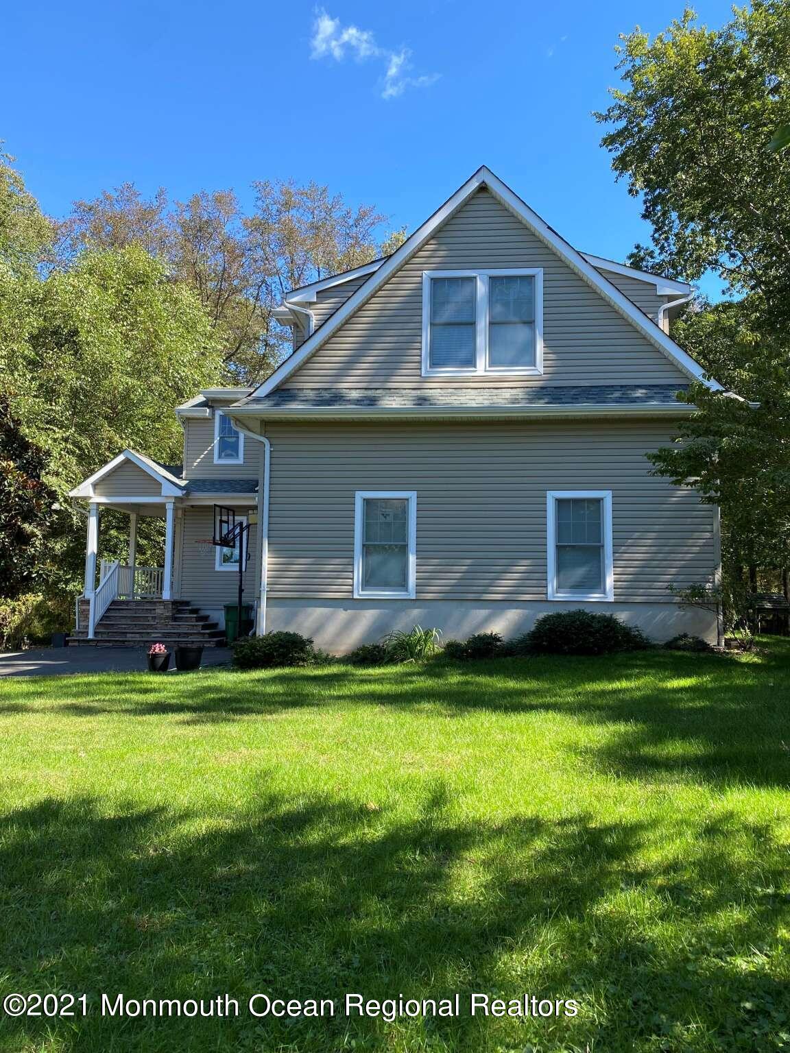 341 Oak Glen Road Howell, NJ 07731 - Photo 2 of 19 a front view of a house with garden