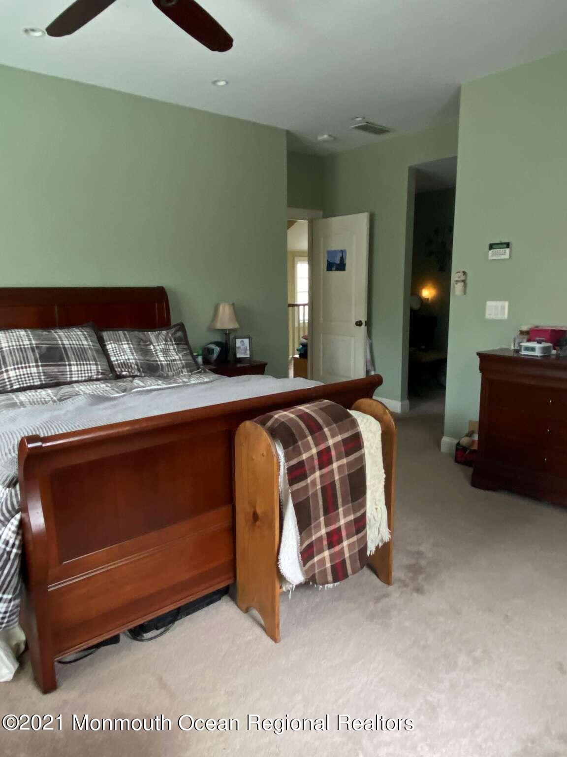 341 Oak Glen Road Howell, NJ 07731 - Photo 13 of 19 a bedroom with a bed and lamp