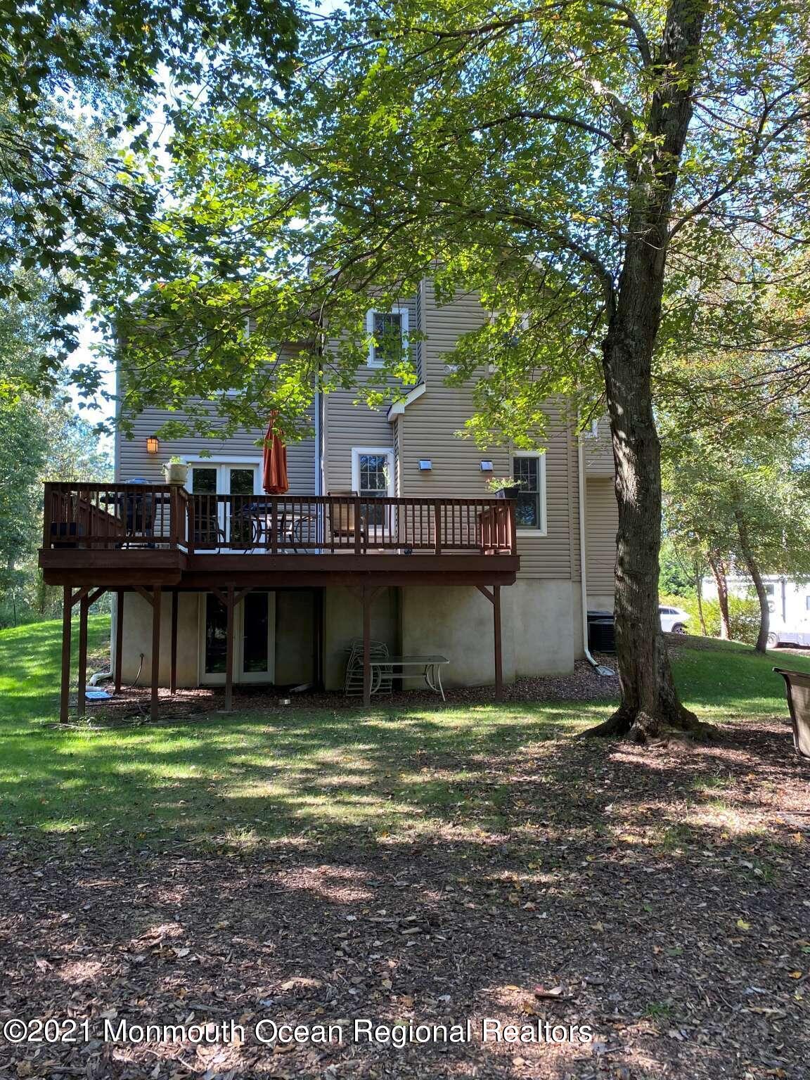 341 Oak Glen Road Howell, NJ 07731 - Photo 3 of 19 a house that has a tree in it