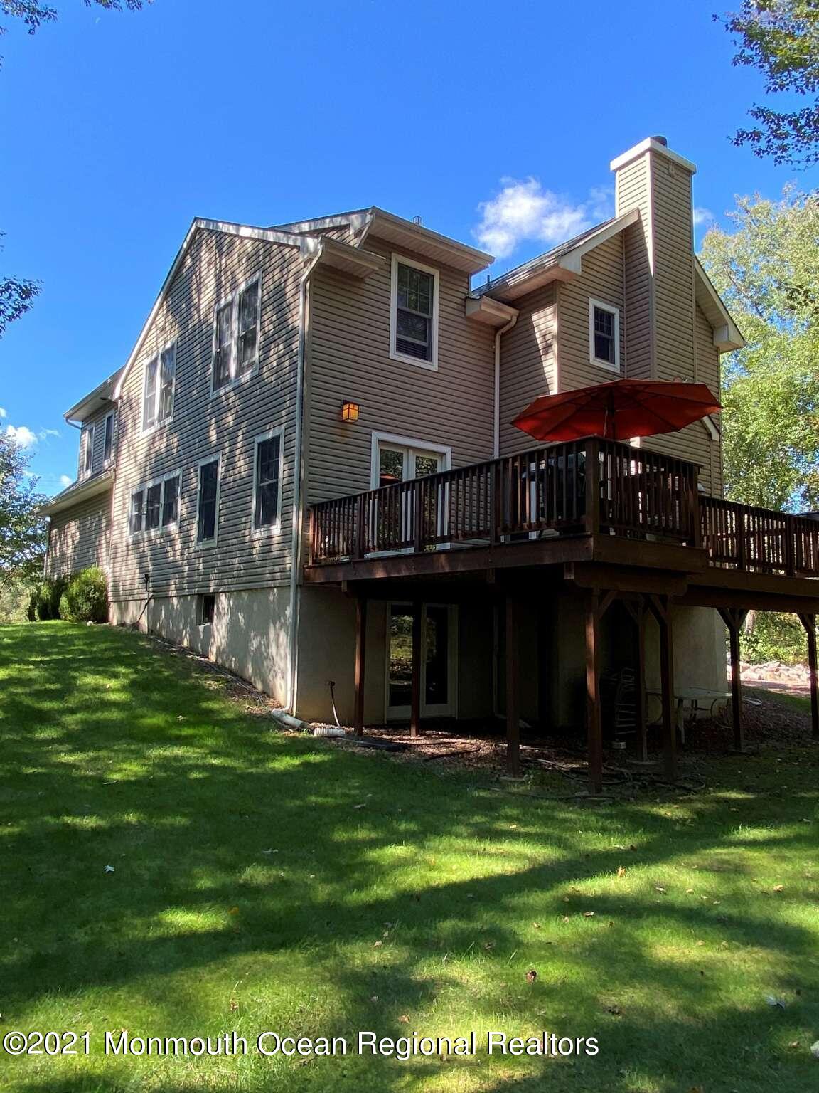 341 Oak Glen Road Howell, NJ 07731 - Photo 4 of 19 a front view of a house with a garden