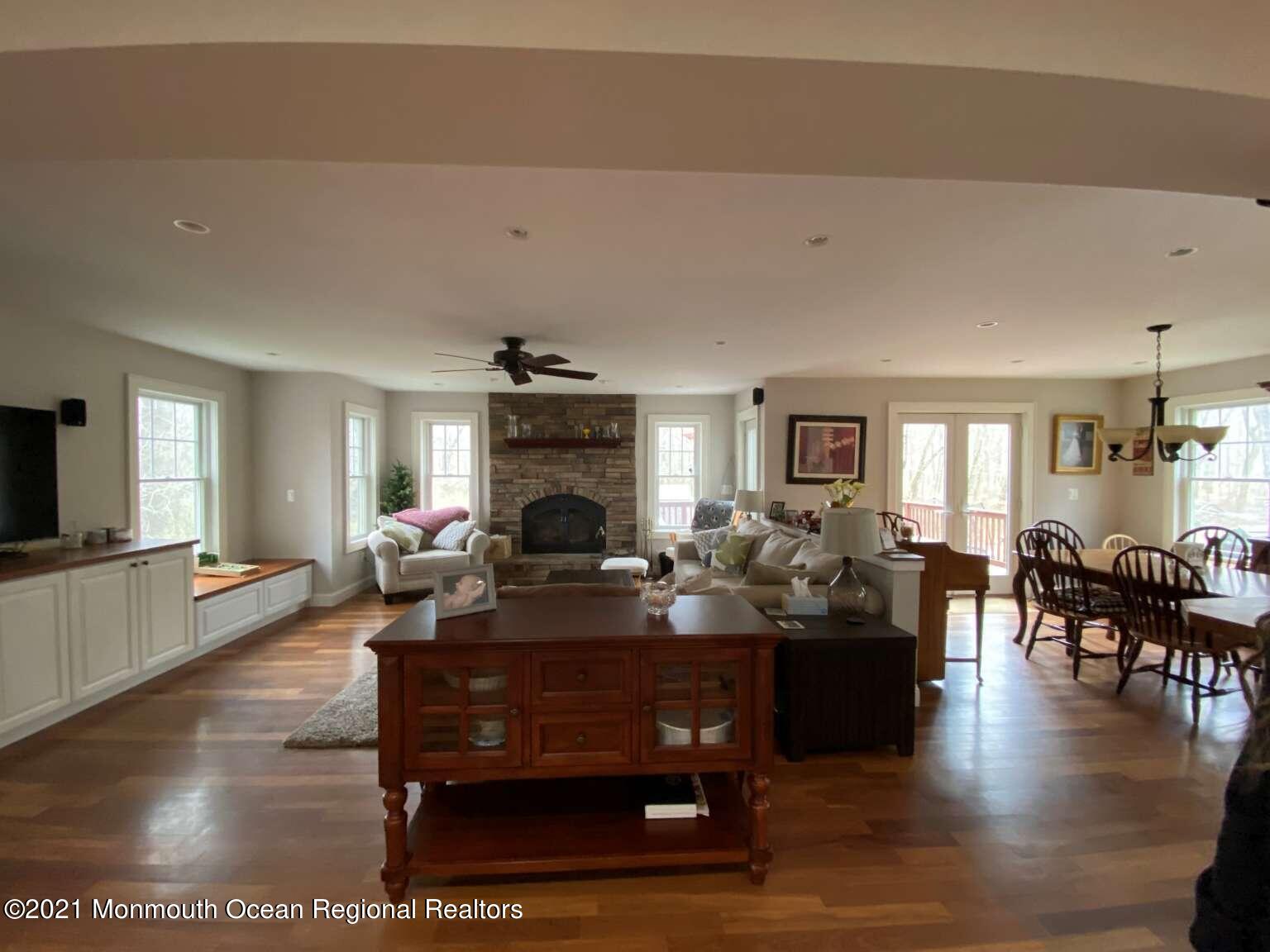 341 Oak Glen Road Howell, NJ 07731 - Photo 6 of 19 a living room with furniture a fireplace and a flat screen tv