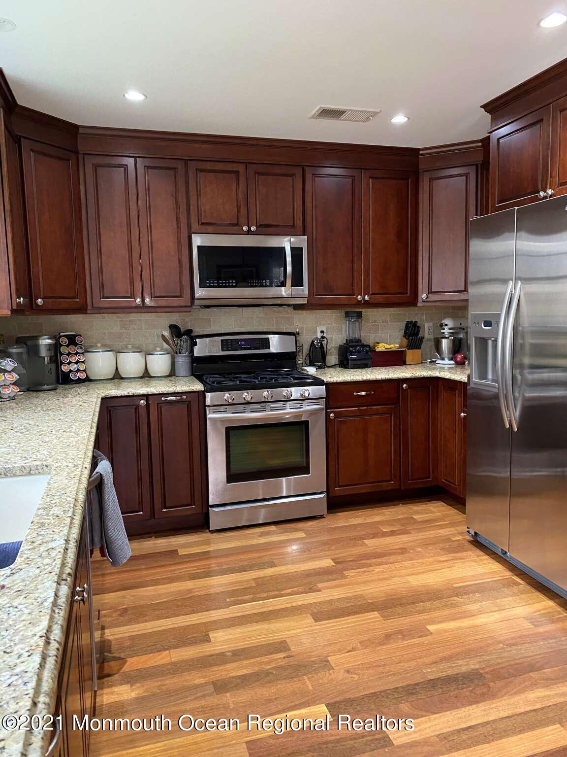 341 Oak Glen Road Howell, NJ 07731 - Photo 9 of 19 a kitchen with wooden cabinets and stainless steel appliances