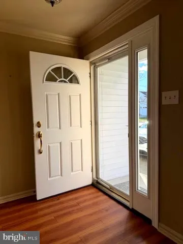 a view of front door with wooden floor