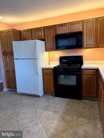 a kitchen with a refrigerator and a stove