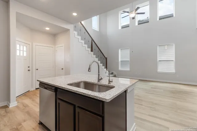 a kitchen with sink cabinets and entryway
