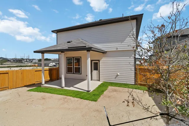 a front view of a house with a garden and yard