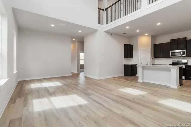 a view of kitchen with microwave and refrigerator