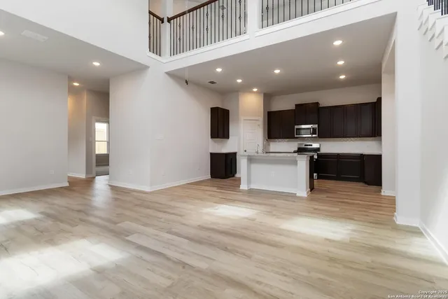 a view of a kitchen with a sink and a refrigerator