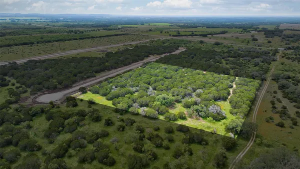 a view of a green field with an outdoor space